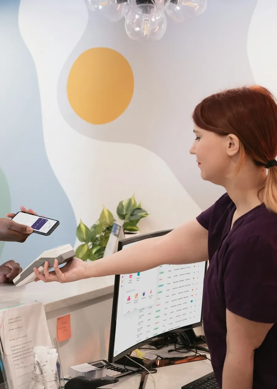 Front desk staff taking payment next to the clinic system